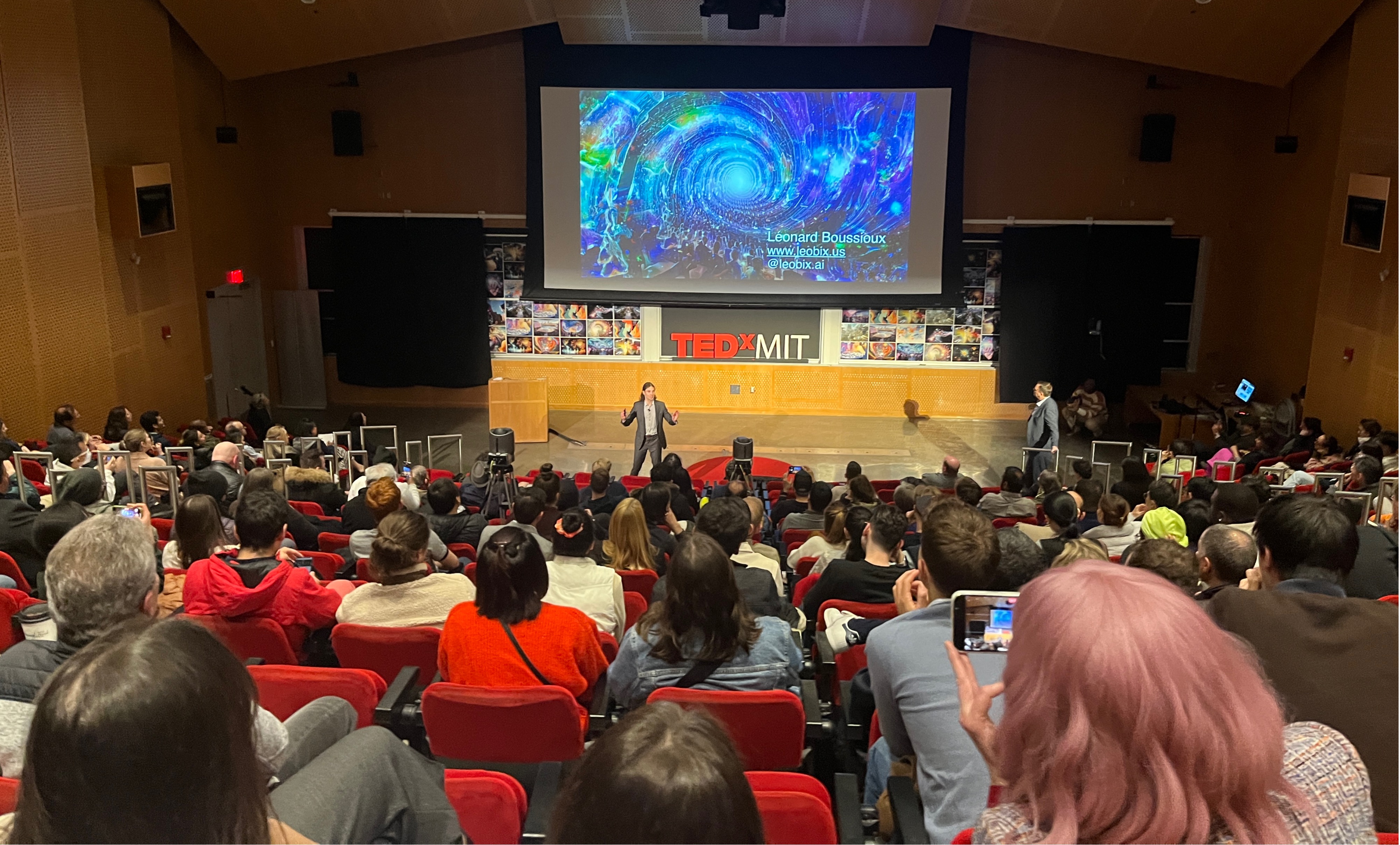 Léonard Boussioux speaking on stage at TEDxMIT